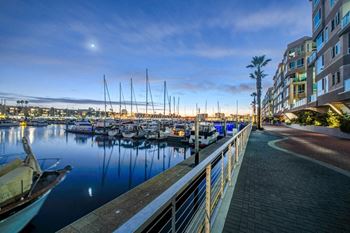 A marina with boats docked and a building on the right.